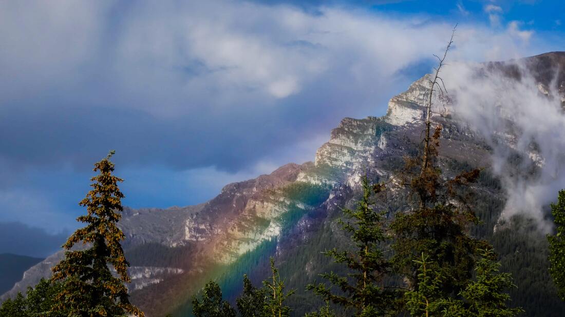 A rainbow over a mountain.